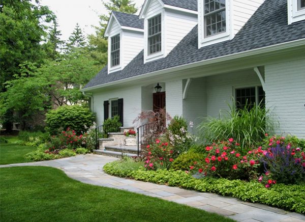 A foundation garden that is in full bloom