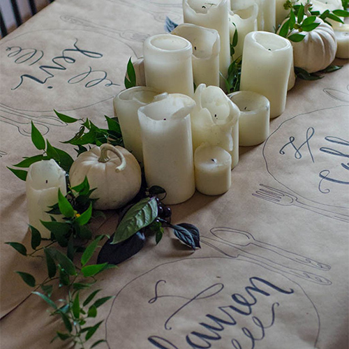 Cover the table with craft paper and add bits of fresh greenery (whatever’s handy), candles, and baby white pumpkins.
